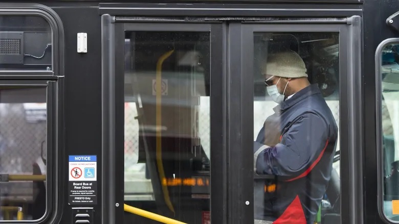 Toronto public transit worker wears a mask in a bus